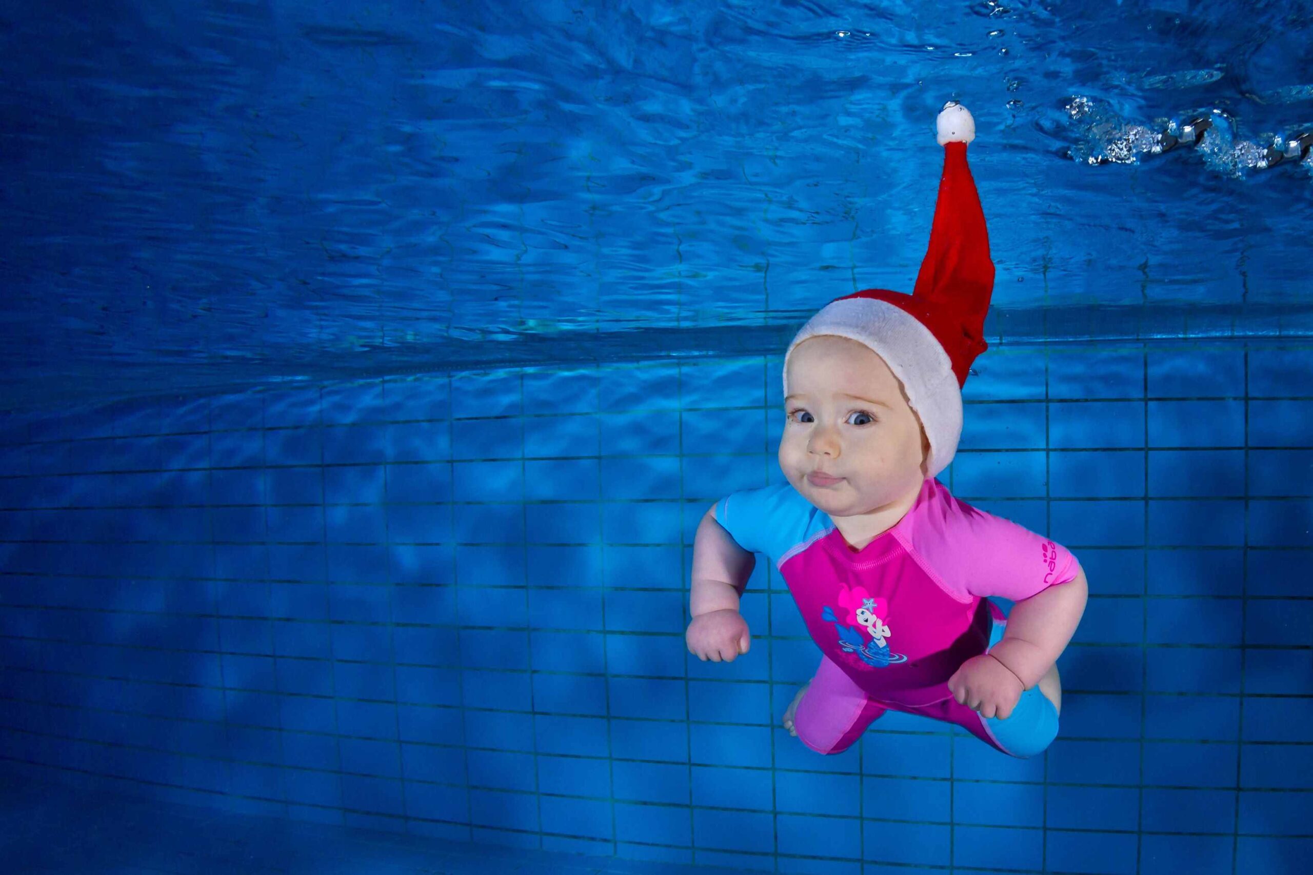 Child in a festive hat at an underwater photoshoot