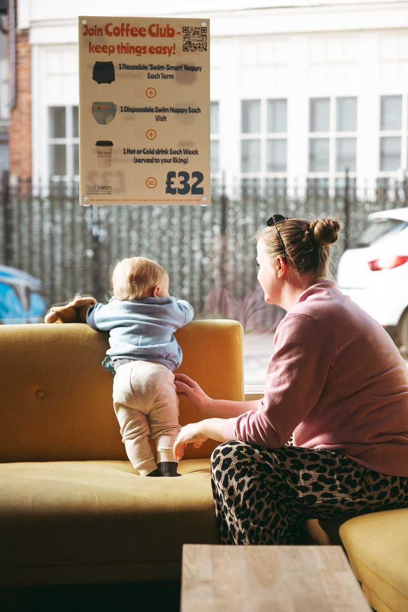 A parent and baby relaxing together in the First Swim coffee shop